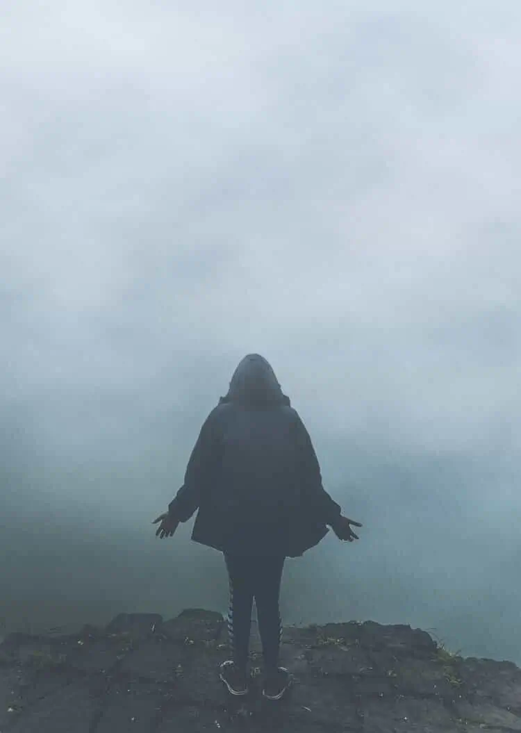 Person standing in fog